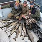 Fishermen with salmon during charter trip